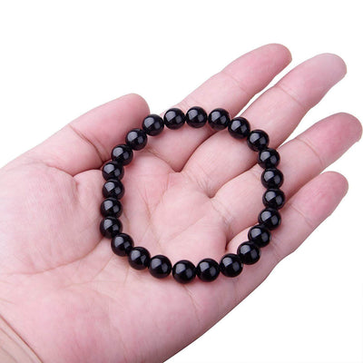 Black Onyx Bracelet displayed on a hand, featuring smooth black agate beads for women.