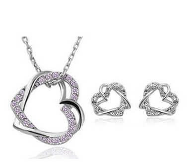Stunning double diamond heart necklace earring set featuring a heart-shaped pendant and matching earrings.